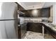 Well-equipped kitchen featuring stainless steel appliances, granite countertops, and stylish dark cabinetry at 2333 Feather Sound Dr # A204, Clearwater, FL 33762