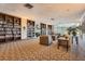 Elegant library area showcasing extensive bookshelves, cozy seating, and a fireplace, perfect for reading at 2333 Feather Sound Dr # A204, Clearwater, FL 33762