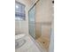 Updated bathroom featuring tiled shower and a modern commode at 2422 W State St, Tampa, FL 33609