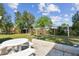 Open back yard with patio, stone seating and a garden at 2908 E 99Th Ave, Tampa, FL 33612