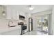 Bright kitchen with stainless steel appliances, white cabinetry, and modern countertops at 2908 E 99Th Ave, Tampa, FL 33612