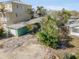 Aerial view showcasing a waterfront property with dock, boat, and tropical trees at 300 16Th Ave, Indian Rocks Beach, FL 33785