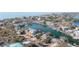 Aerial view of a waterfront house with a dock, boats, and lush landscaping near the beach at 300 16Th Ave, Indian Rocks Beach, FL 33785