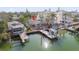 Aerial view showcasing a waterfront house with a boat dock and lush landscaping at 300 16Th Ave, Indian Rocks Beach, FL 33785