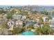 Aerial view of a waterfront neighborhood with homes, canals, and a city skyline in the distance at 300 16Th Ave, Indian Rocks Beach, FL 33785