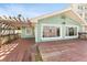 View of large wooden deck with railings and partial pergola, showcasing the home's rear exterior at 300 16Th Ave, Indian Rocks Beach, FL 33785