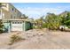 View of the front yard of a home with an attached garage and mature trees at 300 16Th Ave, Indian Rocks Beach, FL 33785