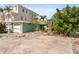 Exterior view of a two-story home with a garage and ample front yard space at 300 16Th Ave, Indian Rocks Beach, FL 33785