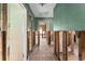 View of an interior hallway showcasing tiled flooring, partial walls, and doorway, in need of renovations at 300 16Th Ave, Indian Rocks Beach, FL 33785