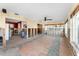 Spacious living room featuring tile flooring, ceiling fan, and views to multiple rooms, renovation needed at 300 16Th Ave, Indian Rocks Beach, FL 33785