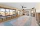 Open living room with tile flooring and multiple windows leading to an outdoor deck at 300 16Th Ave, Indian Rocks Beach, FL 33785