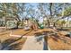 Gathering-friendly playground with varied equipment surrounded by mature oak trees at 300 16Th Ave, Indian Rocks Beach, FL 33785