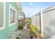A side yard featuring a fenced-in walkway and a glimpse of the waterway at 300 16Th Ave, Indian Rocks Beach, FL 33785