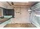 View of a storage room featuring a workbench, concrete walls, and hanging electrical wires at 300 16Th Ave, Indian Rocks Beach, FL 33785