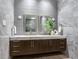 Elegant bathroom with double vanity, marble countertops, designer fixtures, and modern grey tile at 3030 W Santiago St # 3, Tampa, FL 33629