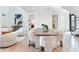 Open-concept layout showcases a stylish dining area with modern table and chairs, adjacent to the cozy living space at 3030 W Santiago St # 3, Tampa, FL 33629