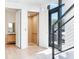 Hallway featuring convenient elevator access, modern design, and a glimpse into a well-appointed bathroom at 3030 W Santiago St # 3, Tampa, FL 33629