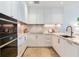 Modern kitchen with white cabinetry, marble backsplash, stainless steel appliances, and gold hardware at 3030 W Santiago St # 3, Tampa, FL 33629