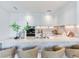 Open kitchen featuring a large marble island with seating, modern appliances, and stylish decor at 3030 W Santiago St # 3, Tampa, FL 33629