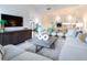 Living room with staircase, a view into the kitchen, a large sectional sofa, and stylish decor at 3030 W Santiago St # 3, Tampa, FL 33629
