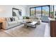 Bright living room featuring a large sectional sofa, stylish decor, and a large window with natural light at 3030 W Santiago St # 3, Tampa, FL 33629