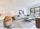 Open concept living space with kitchen bar, large sectional sofa, stylish decor, and ample light at 3030 W Santiago St # 3, Tampa, FL 33629