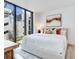 Bright main bedroom with a large window, a king bed, and modern decor at 3030 W Santiago St # 3, Tampa, FL 33629