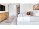 Beautiful main bedroom featuring a sleek TV, stylish dresser, and views of an ensuite at 3030 W Santiago St # 3, Tampa, FL 33629
