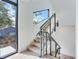 Modern staircase featuring wood steps, metal railings, and plenty of natural light at 3030 W Santiago St # 3, Tampa, FL 33629