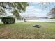 Lush backyard with a fire pit and a privacy fence, perfect for outdoor enjoyment at 3206 Hurley Grove Way, Valrico, FL 33596