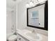 Bright bathroom featuring a shower-tub combo and a vanity with a large framed mirror at 3206 Hurley Grove Way, Valrico, FL 33596