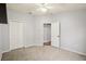 This bedroom has neutral carpeting, a ceiling fan, 2 closets and a view into another room at 3206 Hurley Grove Way, Valrico, FL 33596