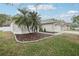 Charming home with a well-manicured lawn and beautiful landscaping, showcasing curb appeal at 3206 Hurley Grove Way, Valrico, FL 33596