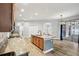 Open eat-in kitchen leading to a spacious living area and featuring granite counters and stainless appliances at 3206 Hurley Grove Way, Valrico, FL 33596