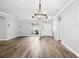 Living room featuring hardwood floors, neutral walls, arched doorways, and modern lighting fixtures at 3206 Hurley Grove Way, Valrico, FL 33596