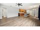 Open-concept living space with hardwood floors flowing to a kitchen with stainless appliances and a center island at 3206 Hurley Grove Way, Valrico, FL 33596