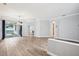 Spacious living room with wood floors, neutral walls, modern chandelier, and access to the backyard at 3206 Hurley Grove Way, Valrico, FL 33596