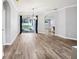 Inviting living room with hardwood floors, modern lighting, and sliding doors leading to the outdoor space at 3206 Hurley Grove Way, Valrico, FL 33596