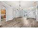 Bright, open living space with hardwood floors, recessed lighting, arched doorways, and elegant chandelier at 3206 Hurley Grove Way, Valrico, FL 33596