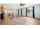 Bright living room featuring hardwood floors, recessed lighting, and sliding glass doors leading to the backyard at 3206 Hurley Grove Way, Valrico, FL 33596