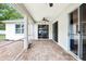 Covered patio with ceiling fan, sliding glass doors, and brick pavers at 3206 Hurley Grove Way, Valrico, FL 33596
