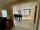 Bright dining room with a modern table set, neutral tile, and views to the living room at 34161 Juniper N Dr, Pinellas Park, FL 33781