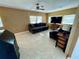 Comfortable living room with neutral tile flooring, ceiling fan, and plentiful natural light at 34161 Juniper N Dr, Pinellas Park, FL 33781