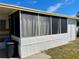 Enclosed sunroom with screening, adjacent to the main structure of the mobile home at 34161 Juniper N Dr, Pinellas Park, FL 33781