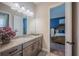 Bathroom featuring a granite vanity with storage and a bedroom view at 4206 Tour Trce, Land O Lakes, FL 34638