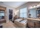 Bathroom with double vanity sinks, a soaking tub and tiled floors at 4206 Tour Trce, Land O Lakes, FL 34638