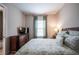 Cozy bedroom featuring carpeted floors, a window, and warm, neutral paint at 4206 Tour Trce, Land O Lakes, FL 34638
