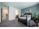 Comfortable bedroom featuring a queen-size bed, neutral carpet, and ensuite bathroom entrance at 4206 Tour Trce, Land O Lakes, FL 34638