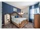 Comfortable bedroom boasting a queen-size bed, accent wall, and carpet flooring at 4206 Tour Trce, Land O Lakes, FL 34638