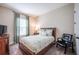 Comfortable bedroom with a window, carpeted flooring, and ample natural light at 4206 Tour Trce, Land O Lakes, FL 34638